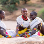Beautiful Rendile girls watch on as we photograph morans at sunrise in the Ndoto Mountains (image by Inger Vandyke)