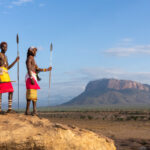 Samburu morans with their spears and Mount Ololokwe in the background (image by Inger Vandyke)