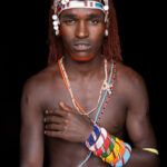 A Samburu Moran wearing a traditional helmet called a Yema (image by Inger Vandyke)