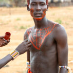 Painting the body of a Samburu Moran (image by Inger Vandyke)