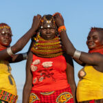 Turkana girls playing with the hair of their friend (image by Inger Vandyke)