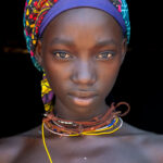 Before they go through their initiation and begin to wear their beehive hair, Nguendelengo girls wear a simple headscarf (image by Inger Vandyke)