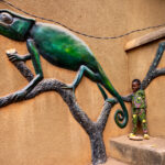 A young boy enjoys posing for the camera with a chameleon (image by Ingrid Koedood)