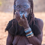 An elderly Ovatwa woman smokes her pipe (image by Inger Vandyke)