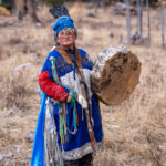 Portrait of Tsegtseg with her drum in the forest (image by Inger Vandyke)