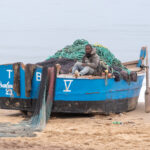 A fisherman and his boat at Tombua (image by Inger Vandyke)