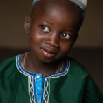 The shy smile of a beautiful young Fulani boy (image by Ingrid Koedood)