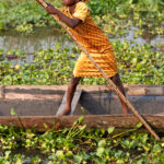 Children learn to navigate the canoe at a young age in Ganvie, honing their skills in the serene waters as part of their daily life in this unique water village (image by Ingrid Koedood)
