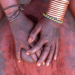 Grinding the red ochre that is used in body adornment by Ovahimba people (image by Inger Vandyke)