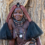 Portrait of a beautiful Ovahimba girl under a large mopane tree (image by Inger Vandyke)