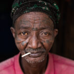 The heavilly tattooed face of a prominent Holi elder (image by Ingrid Koedood)