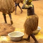 A young Kokou adherent covers his body in a mix of Kaolin powder and yellow palm oil (image by Ingrid Koedood)