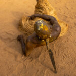 A Kokou devotee rests on his large knife that he used to self-mutilate in a show or power to the voodoo gods (image by Ingrid Koedood)