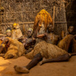 Kokou devotees rest against their shrine in remote Benin (image by Ingrid Koedood)