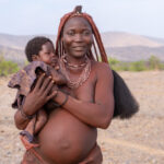 A pregnant Ovahimba woman with her beautiful child (image by Inger Vandyke)