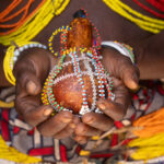 Ovamwila holding a decorative gourd in her hands (image by Inger Vandyke)