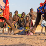 Ovandimba women and children singing and dancing at a ceremony (image by Inger Vandyke)