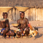 Ovandimba girls with their baskets and chickens (image by Inger Vandyke)