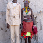A traditional Ovandimba headman, or Soba, still wearing his millitary uniform issued by Portugal, with his traditional wife in Southern Angola (image by Inger Vandyke)