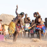 Dancing in the dust. Ovandimba women dance at a ceremony in Southern Angola (image by Inger Vandyke)