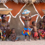Ovandimba women with their children in a traditional village (image by Inger Vandyke)