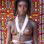 An Ovankhumbi girl against a backdrop of Samakaka, the traditional pattern of Nyaneka people in Angola (image by Inger Vandyke)