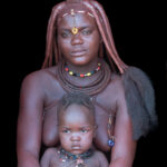 An Ovatwa mother and her baby in the door of her hut (image by Inger Vandyke)