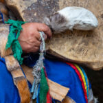 A female shaman holds a drumstick fashioned out of reindeer fur and bone. She uses this with a tamtam drum to summons the forest gods (image by Inger Vandyke)