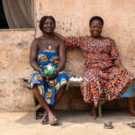 Women sitting in the shade at a remote fishing village near the border of Nigeria (image by Ingrid Koedood)