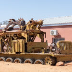 An old Russian military vehicle, too heavy to move, sits slowly being swallowed by sand in an Angolan town (image by Inger Vandyke)