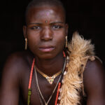Portrait of a young Taneka man dressed for the initiation ceremony in a remote village in the Atacora foothills (image by Ingrid Koedood)