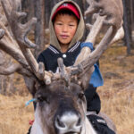 Portrait of a young Tsaatan boy and his Reindeer (image by Inger Vandyke)