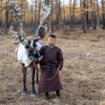 A young Tsaatan boy leading his reindeer back to the community (image by Inger Vandyke)