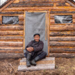 A nomadic Tsaatan man outside the log cabin he will use to shelter from the harsh northern Mongolia winter (image by Inger Vandyke)