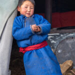 A young Tsaatan boy at the entrance to his Tepee tent (image by Inger Vandyke)