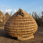 A young Jie boy inside a handmade Ekero, or granary, near the Boma Plateau (image by Inger Vandyke)