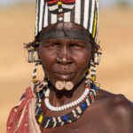 Beautiful Jie woman with her spiral lip piercings and jewellery (image by Inger Vandyke)