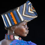 A young Jie girl with her beaded crown (image by Inger Vandyke)