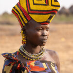 A young Jie woman wearing a large crown of her husband's clan (image by Inger Vandyke)