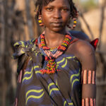 A stunning Jie woman in her village at sunset (image by Inger Vandyke)
