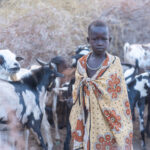 Like so many African tribal people, Laarim children are tasked with herding and milking their animals at sunrise (image by Inger Vandyke)
