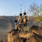 High in the Lopit Hills of South Sudan, a group of warriors embrace a new day (image by Inger Vandyke)