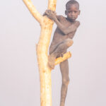 A young Mundari boy atop a camp watch post (image by Inger Vandyke)