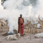 Mundari man standing in the smoke of the camp (image by Inger Vandyke)