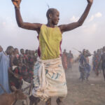 A Mundari man leaping into the air during a wedding celebration (image by Inger Vandyke)