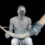Mundari man holding a 'Tung' or musical horn made from Ankole horn (image by Inger Vandyke)