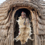 A Toposa girl wearing a ceremonial Serval skin (image by Inger Vandyke)