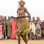 A Toposa woman with her decorated Nyandol skirt at a ceremony (image by Inger Vandyke)