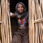 An Arbore woman sitting in front of the doorway of her house (image by Ingrid Koedood)