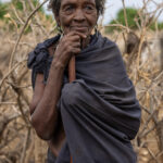 An elderly Arbore woman leaning on a walking stick (image by Ingrid Koedood)